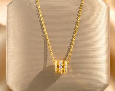 a necklace with a diamond and a gold necklace