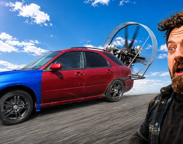 A custom fan-powered car speeding on a road with a surprised man in the foreground.