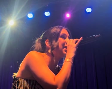 LuxeBand singer performing on stage at a corporate event