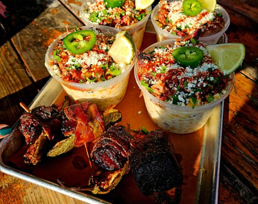 Elote with brisket, cotija cheese, lime and jalapeno with a smoked burnt end with jalapeno
