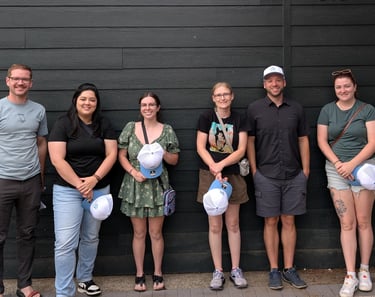 oly paws team members standing in front of a wall