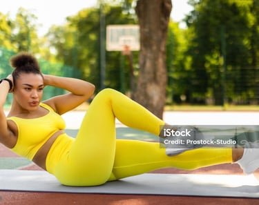 a woman doing a cruncher on a basketball court