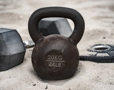 a kettlebell and a pair of dumbells
