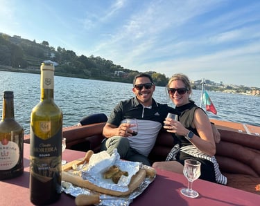 A couple enjoying wine and snacks on the James Bond–style speedboat Eskrok