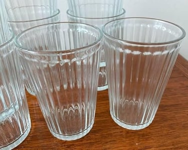 a bunch of glasses and cups on a table