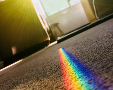 a rainbow - colored light shining through a rainbow - colored light
