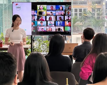 a woman in a white shirt is standing in front of a group of people