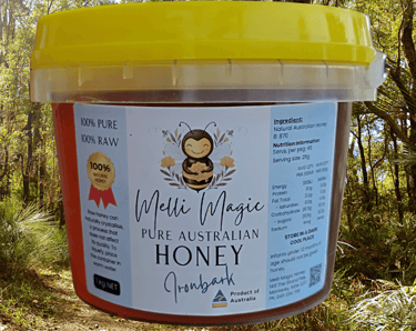 Melli Magic 1kg tub of pure raw Australian Ironbark honey set against a sunny forest background.