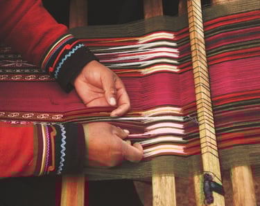 a person holding a piece of handloom fabric