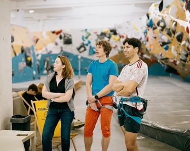 a group of people standing in climbing wall