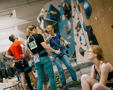 climbers in a climbing wall are checking the rope