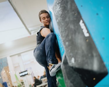 a woman bouldering on a climbing wall