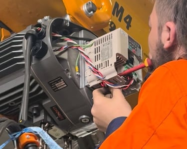 crane technician inspecting and adjusting electrical components
