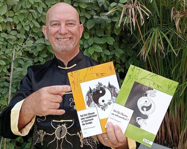 a man in a black shirt holding up a book