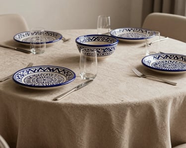 Detail of a luxury dining table setup with traditional Moroccan ceramics in a modern, minimalist style, sand-colored tablecloth.