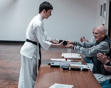 Sensei Dave Kershaw awards student with shodan grade