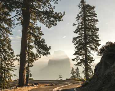 a person riding a bike down a mountain road