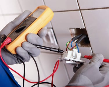 a person in gloves and gloves holding a multimetered device