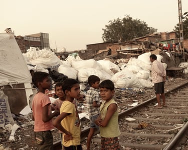 a group of children standing on a train track of Kirti Nagar