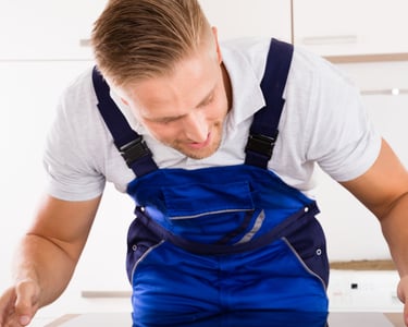 a man in a blue overalls and a white shirt