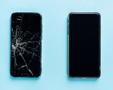 a couple of cell phones with a broken screen