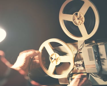 a man is holding a camera and a light bulb