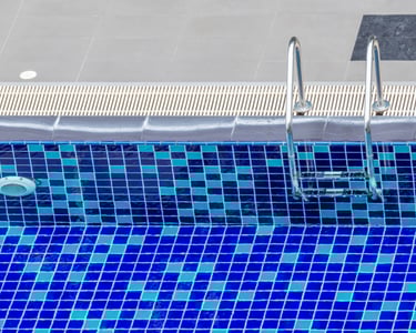 a pool with a blue tiled pool and a swimming pool