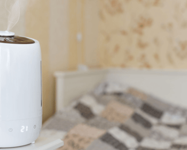 a white humider sitting on top of a bed