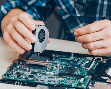 a man is repairing a computer motherboard