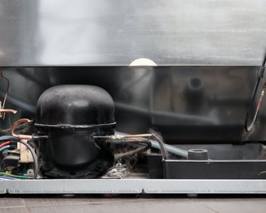 a refrigerator with a large metal container inside