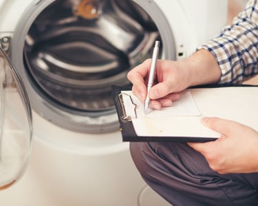 a man in overalls and overalls is writing on a clipboard