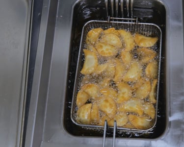 a fryer with potatoes in a fryer