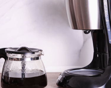a coffee maker with a coffee potted on a counter