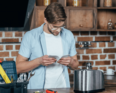 a man in a blue shirt is looking at his phone