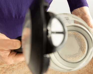 a person holding a coffee potted in a potted pot
