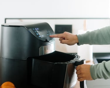 a person is holding a container with oranges