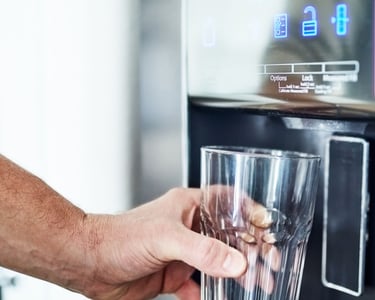 a person holding a glass of water in a glass