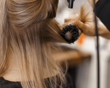 a woman is getting her hair styled with a hairdoodle