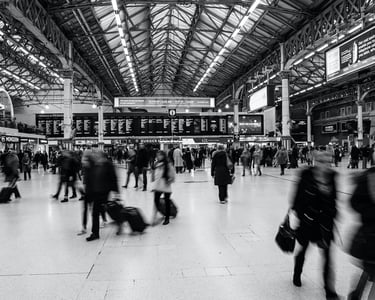a group of people walking through a train station