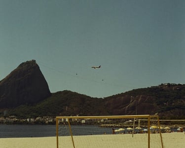 a soccer goalie on a beach with a plane flying over it