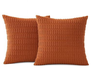 A digital image of two square rust-colored corduroy pillow covers with visible texture