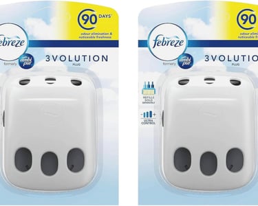 Two Febreze 3Volution plug-in air freshener diffusers in retail packaging for 90-day odor elimination.
