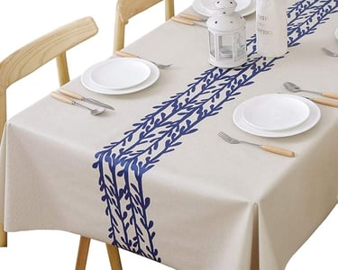 a table with a tablecloth and plates and silverware