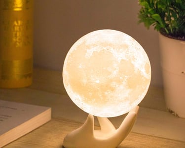 a white moon shaped lamp with a handmade moon