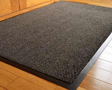a black carpeted area rug with a black rug
