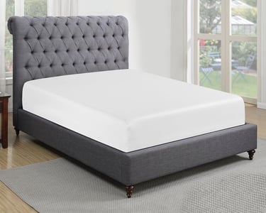 a bed with a gray bed and a chair