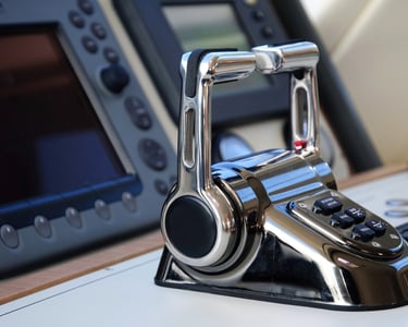 Dual boat throttles with marine electronics in the background.