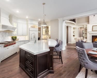 Newly built kitchen featuring custom cabinetry, countertops, flooring, and lighting