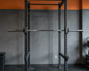 Bright, modern cardio machines lined up in a spacious gym with natural light.