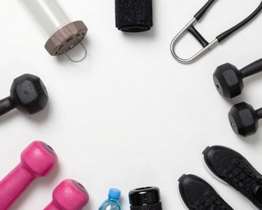 Bright, modern cardio machines lined up in a spacious gym with natural light.